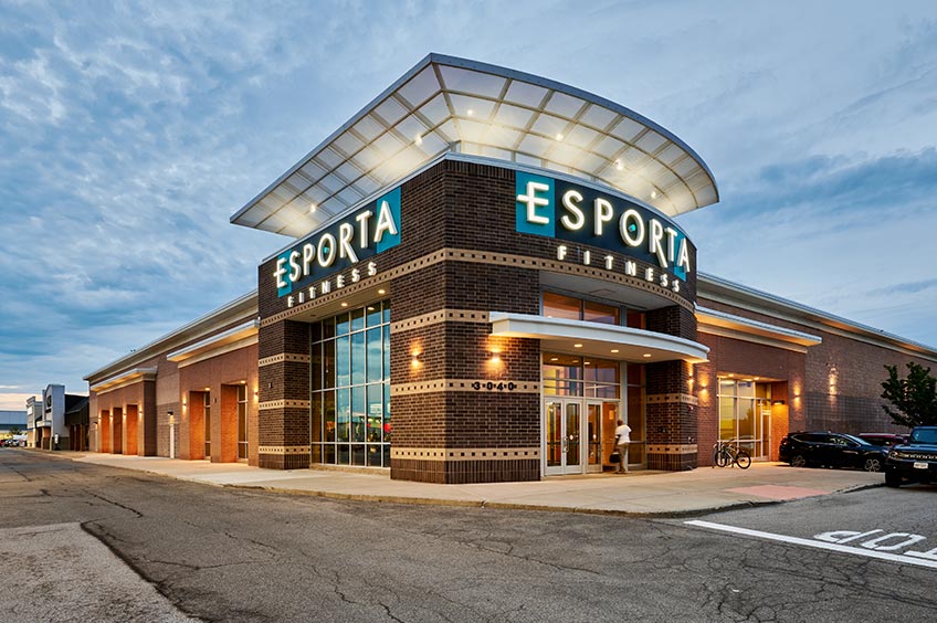 Sidewalk and shop storefront at Amherst Commons shopping center.