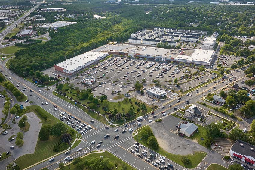 Overhead shot of Brick Commons shopping center and its adjacent parking lot, captured from a high vantage point.