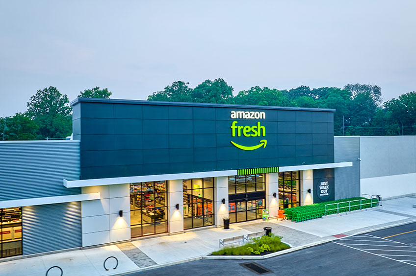 Detailed view of Broomall Commons shopping center with various stores, colorful banners and busy shoppers.