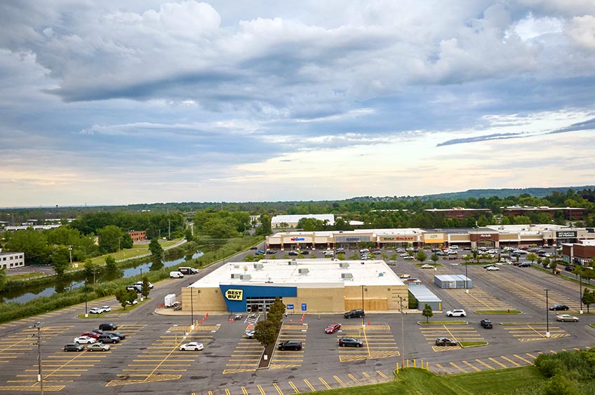 View of Dewitt shopping center with various parking lots.