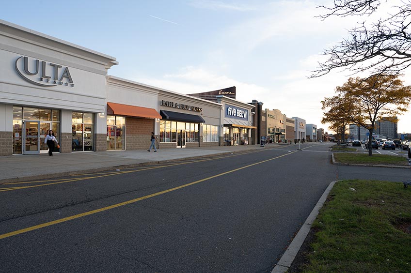 Sidewalk and shop storefront at Gateway Center shopping center.
