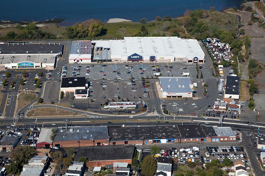 Aerial view of Hudson Commons shopping center and its adjacent parking lot, captured from a high vantage point.