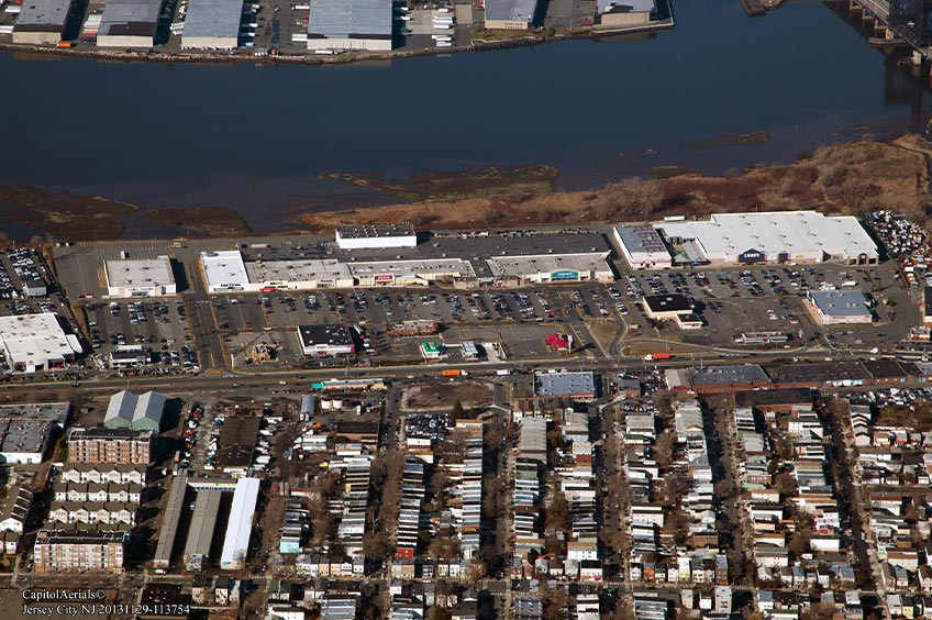 Aerial view of Hudson Mall shopping center and its adjacent parking lot, captured from a high vantage point.