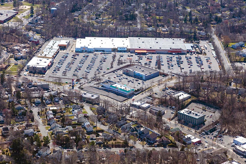 Aerial view of Huntington Commons shopping center and its adjacent parking lot, captured from a high vantage point.