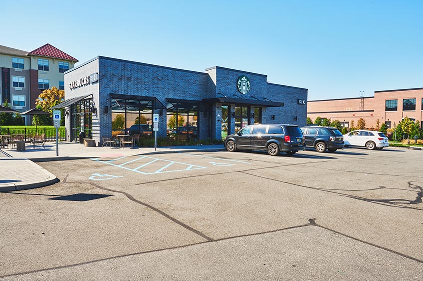 Storefront at Kearny Commons shopping center and parking spaces.