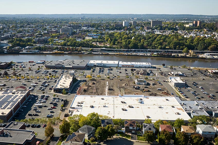 Aerial view of Kearny Commons shopping center and its adjacent parking lot, captured from a high vantage point.