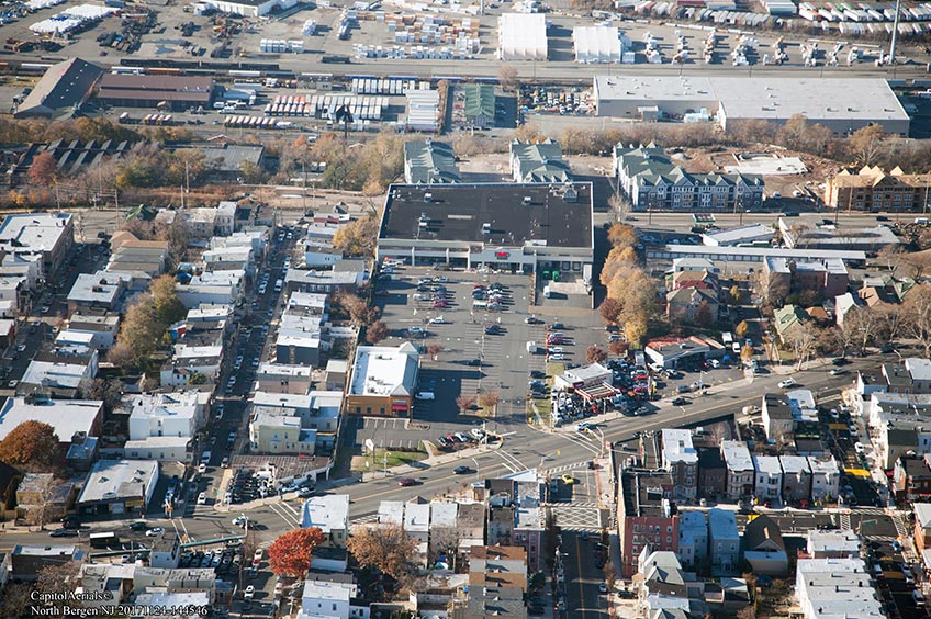 Aerial view of Kennedy Commons shopping center and its adjacent parking lot, captured from a high vantage point.