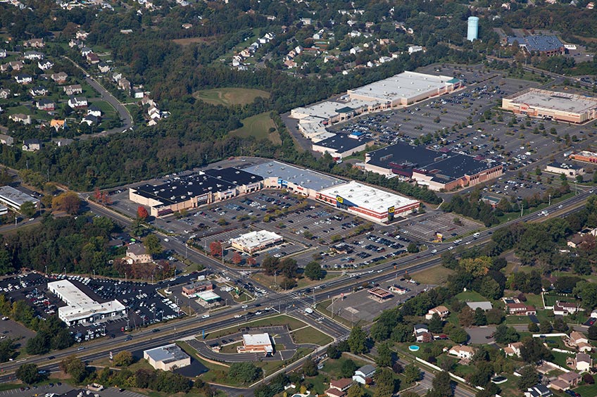 Aerial view of Manalapan Commons shopping center and its adjacent parking lot, captured from a high vantage point.