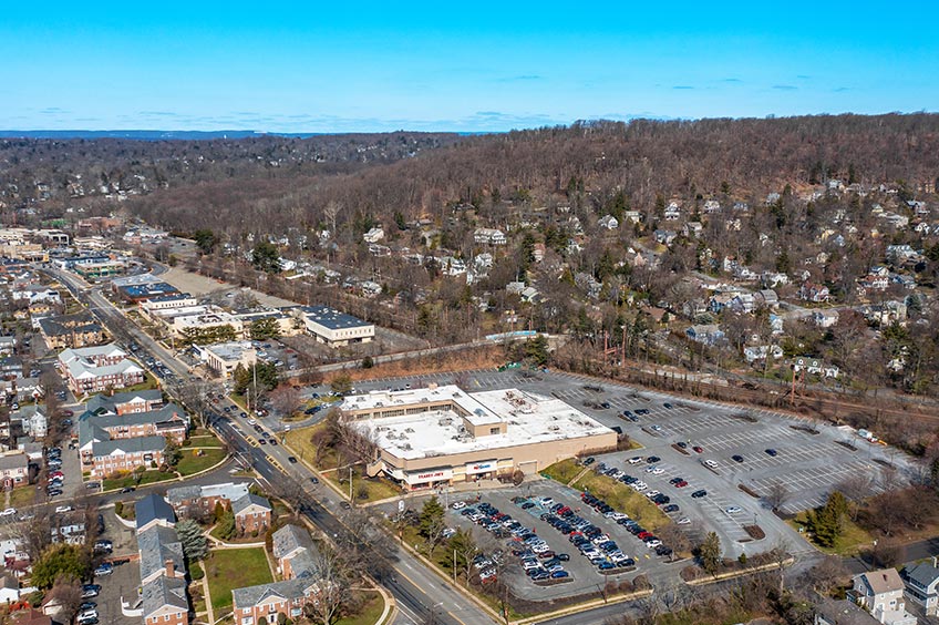 Aerial view of Millburn Gateway Center shopping center and its adjacent parking lot, captured from a high vantage point.