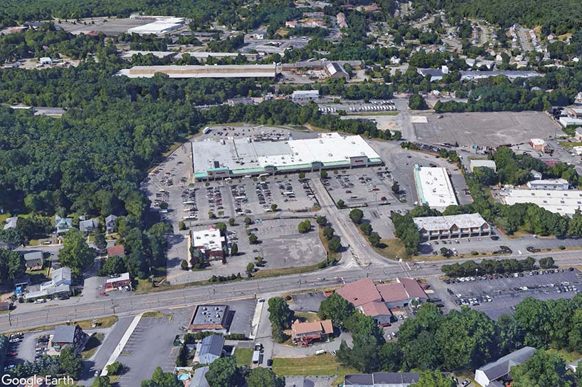 Aerial view of Rockaway River Commons shopping center and its adjacent parking lot, captured from a high vantage point.