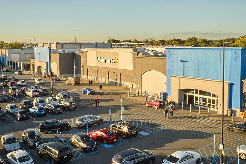 Tonnelle Commons shopping center with various shops and parking spaces.