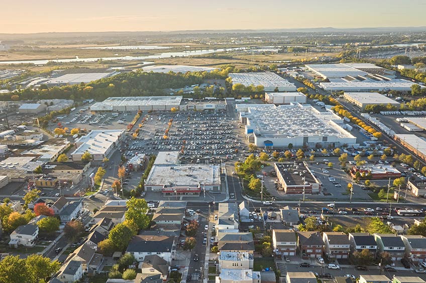 Aerial view of Tonnelle Commons shopping center and its adjacent parking lot, captured from a high vantage point.