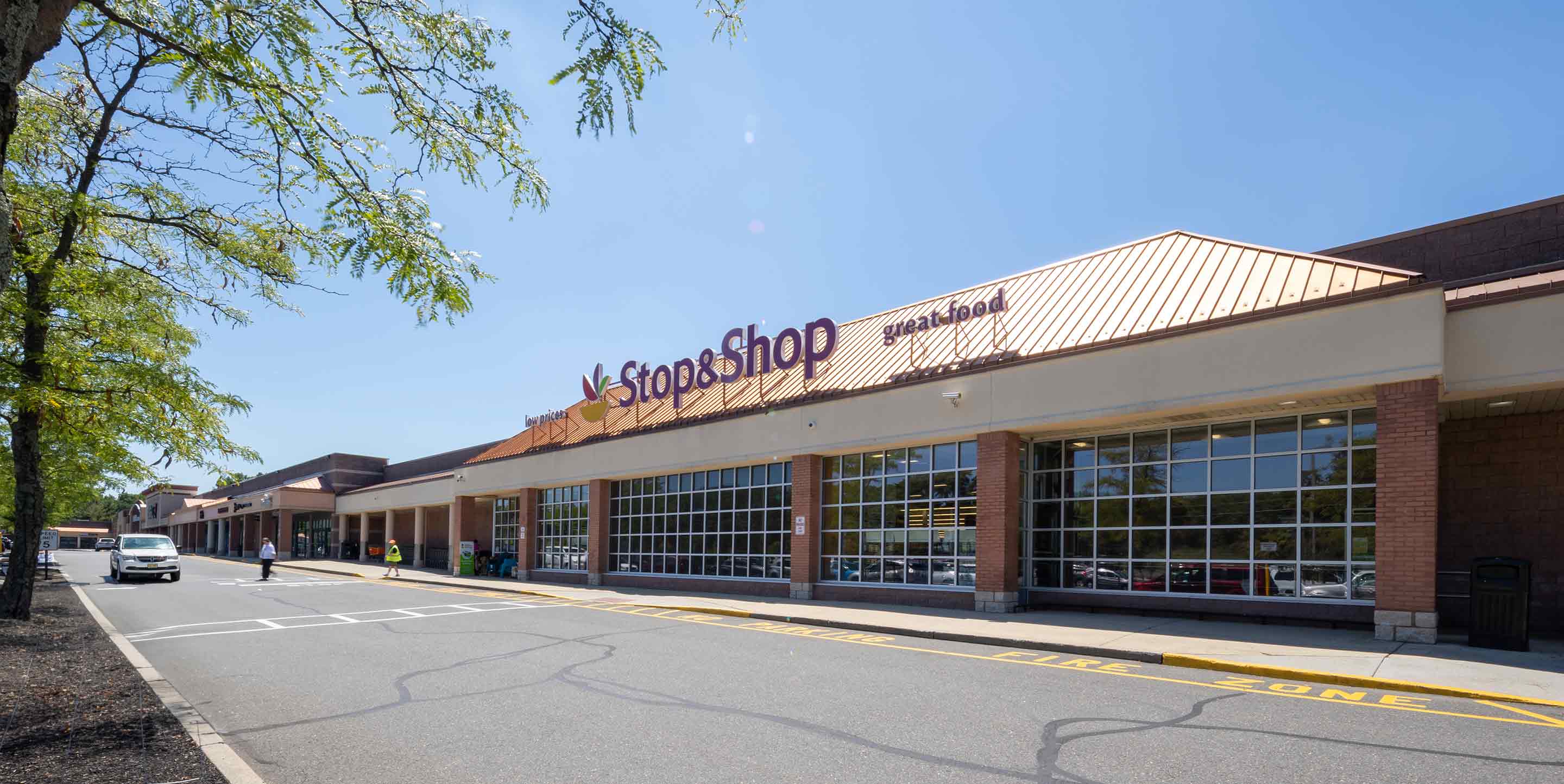 Image of Town Brook Commons shopping center with various shops.