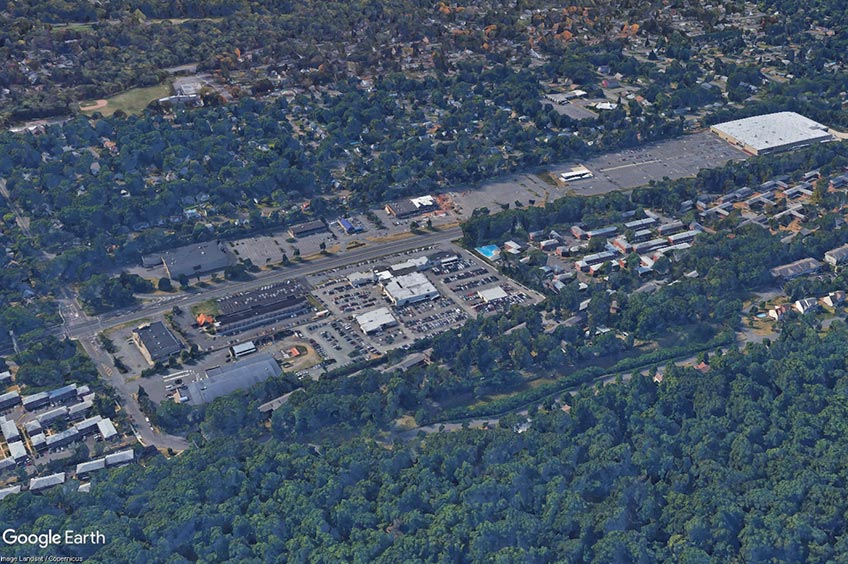 Aerial view of West End Commons shopping center and its adjacent parking lot, captured from a high vantage point.