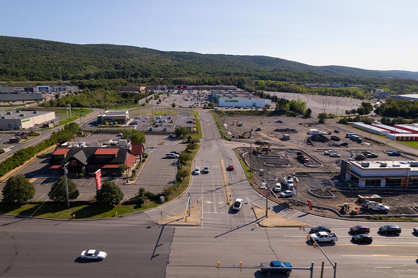 Aerial view of Wilkes-Barre Commons shopping center and its adjacent parking lot, captured from a high vantage point.