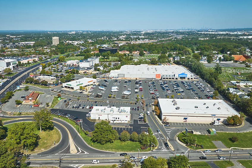 Aerial view of Woodbridge Commons shopping center and its adjacent parking lot, captured from a high vantage point.