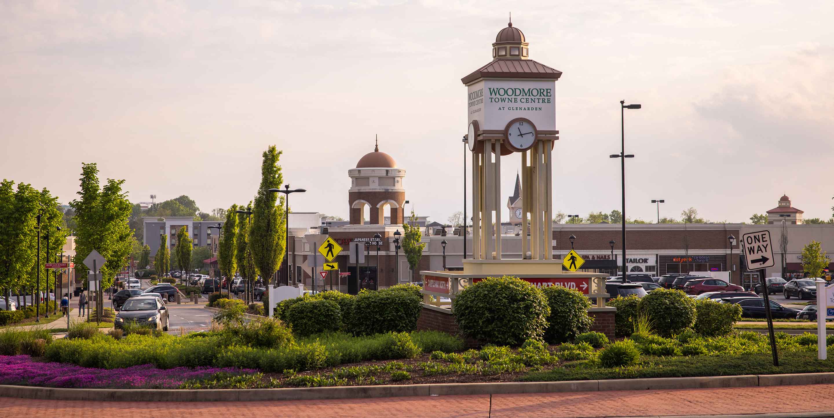 Main image of Woodmore Towne Centre shopping center with various stores.
