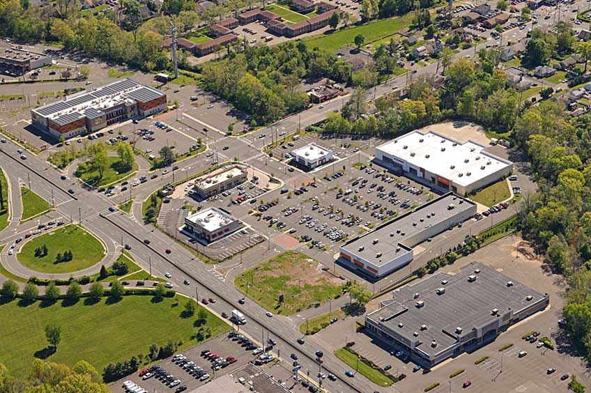 Aerial view of Heritage Square shopping center and its adjacent parking lot, captured from a high vantage point.