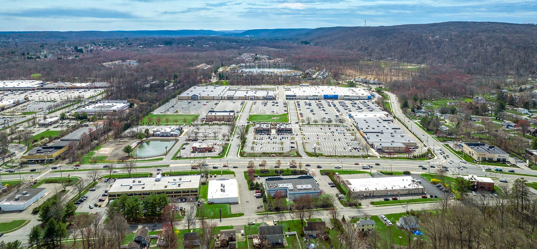 Aerial view of Ledgewood Commons shopping center and its adjacent parking lot, captured from a high vantage point.