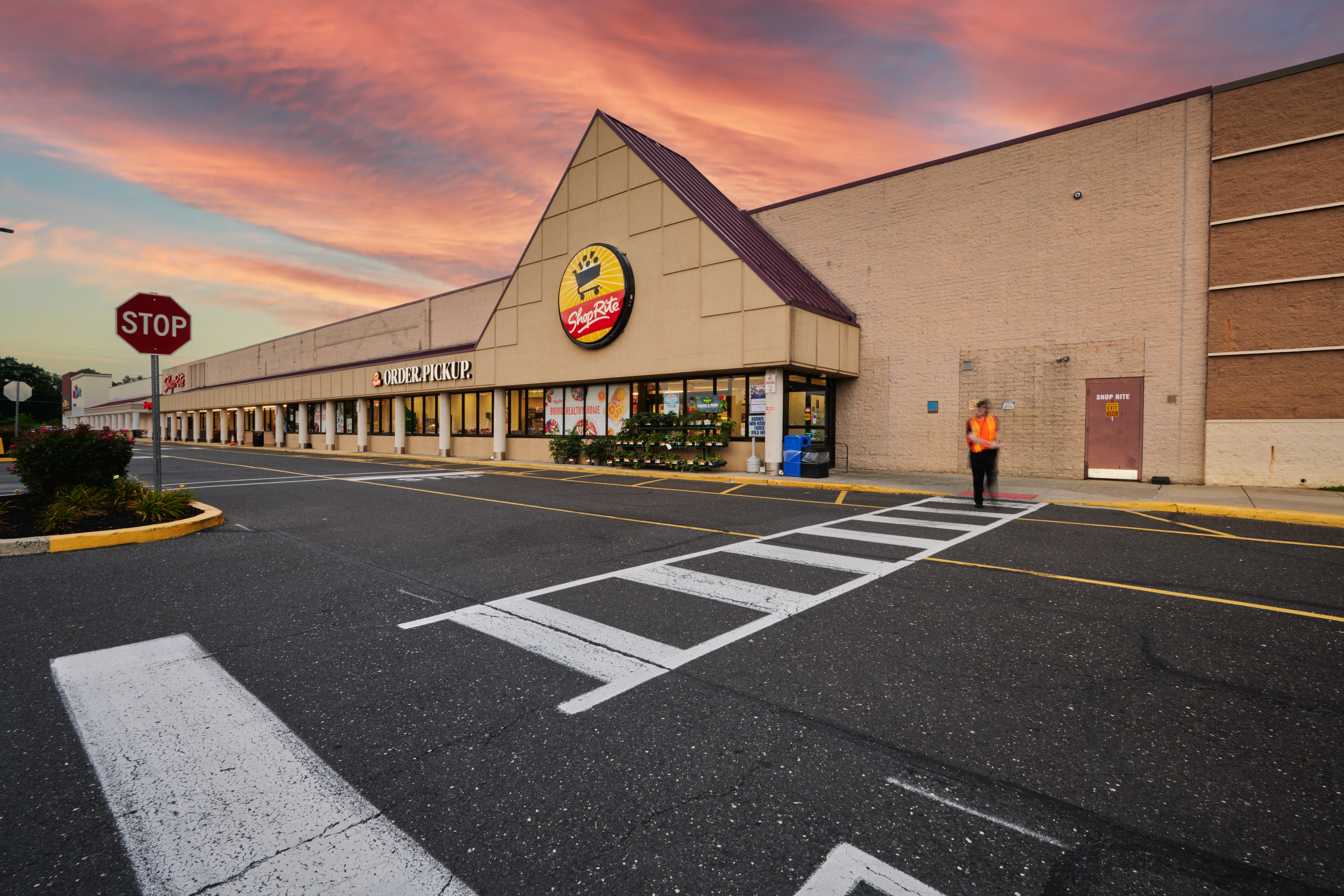 Ground view of Shop Rite at dusk with pink and blue clouds in the sky