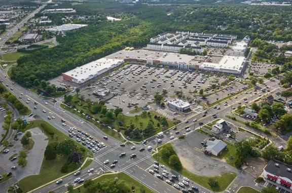 Overhead shot of Brick Commons shopping center and its adjacent parking lot, captured from a high vantage point.