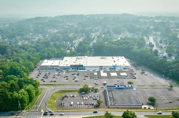 Overhead shot of Broomall Commons shopping center and its adjacent parking lot, captured from a high vantage point.