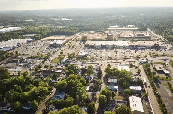 Overhead shot of Brunswick Commons shopping center and its adjacent parking lot, captured from a high vantage point.