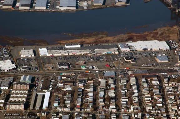 Aerial view of Hudson Mall shopping center and its adjacent parking lot, captured from a high vantage point.