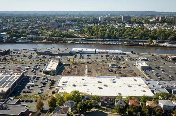 Aerial view of Kearny Commons shopping center and its adjacent parking lot, captured from a high vantage point.