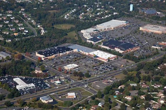 Aerial view of Manalapan Commons shopping center and its adjacent parking lot, captured from a high vantage point.