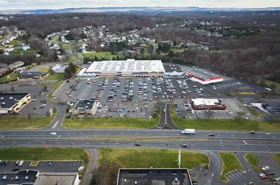 Aerial view of Newington Commons shopping center and its adjacent parking lot, captured from a high vantage point.