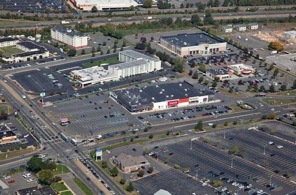 Aerial view of Stelton Commons shopping center and its adjacent parking lot, captured from a high vantage point.