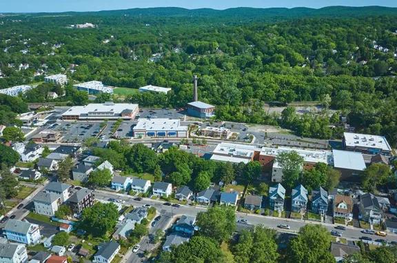 Aerial view of The Shops at Riverwood shopping center and its adjacent parking lot, captured from a high vantage point.