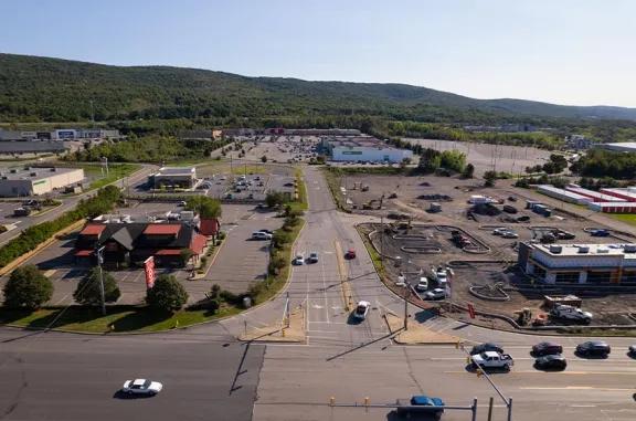 Aerial view of Wilkes-Barre Commons shopping center and its adjacent parking lot, captured from a high vantage point.
