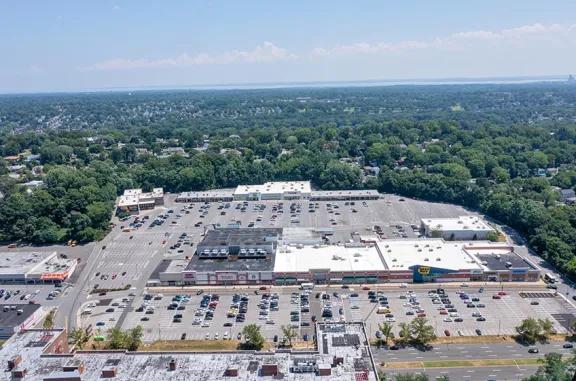 Overhead shot of Yonkers Gateway Center shopping center and its adjacent parking lot, captured from a high vantage point.